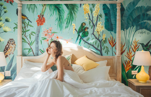 Woman in bed of a coco casita   
