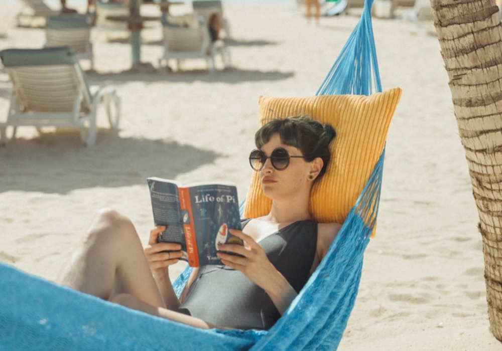 Girl reading a book in a hammock