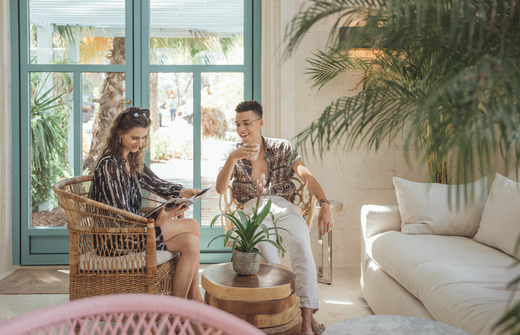 two persons sitting in the lobby