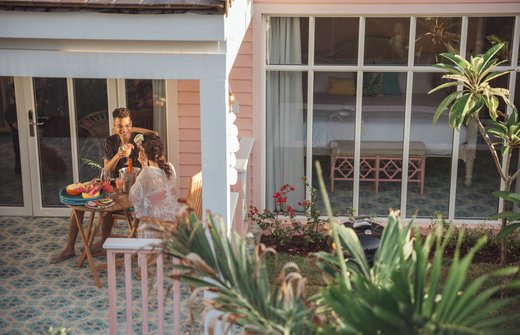 Couple relaxing on patio of plunge pool casita