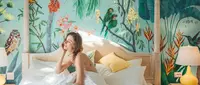 Girl in bed with exotic painted mural 